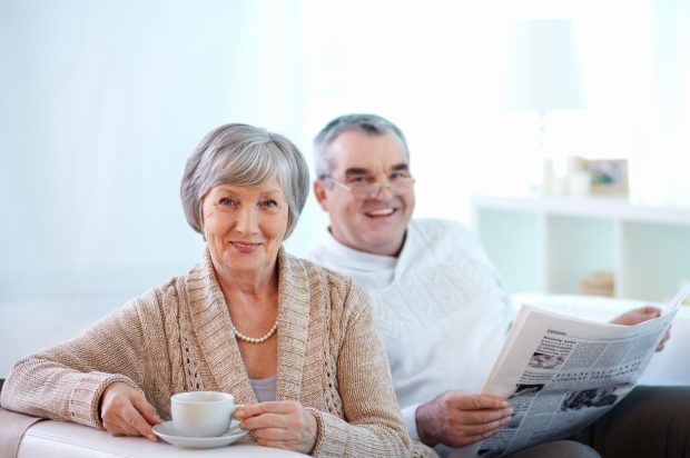 Portrait of happy senior woman and her husband at home